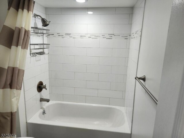 bathroom with shower / bath combination with curtain