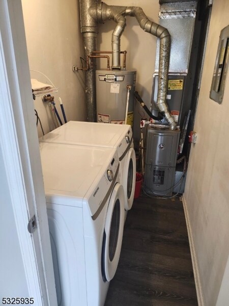 laundry room featuring separate washer and dryer, dark hardwood / wood-style floors, heating unit, and gas water heater