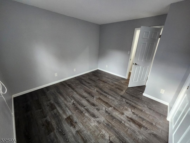 empty room featuring dark wood-type flooring