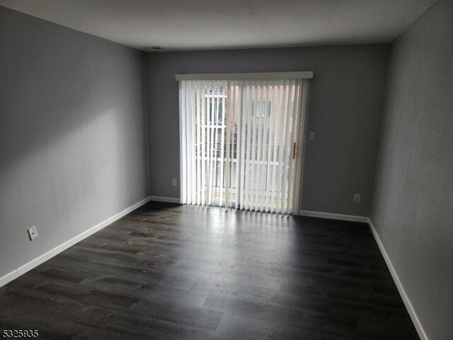 empty room with dark wood-type flooring