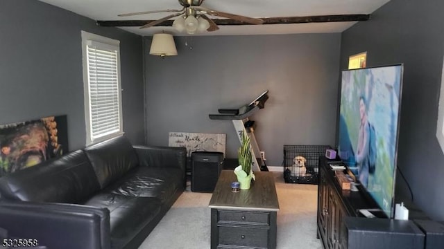 living room with light carpet and beam ceiling