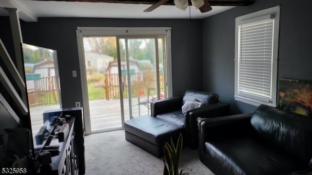 living area featuring ceiling fan and light colored carpet