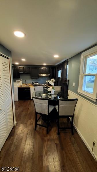 dining space featuring dark wood-type flooring