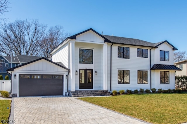 modern inspired farmhouse with a garage, a front lawn, and french doors