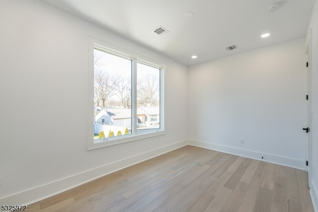 spare room featuring light hardwood / wood-style floors