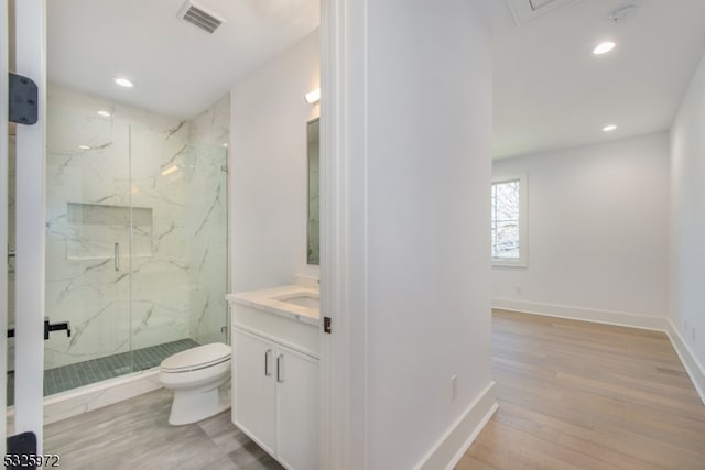 bathroom with vanity, an enclosed shower, wood-type flooring, and toilet