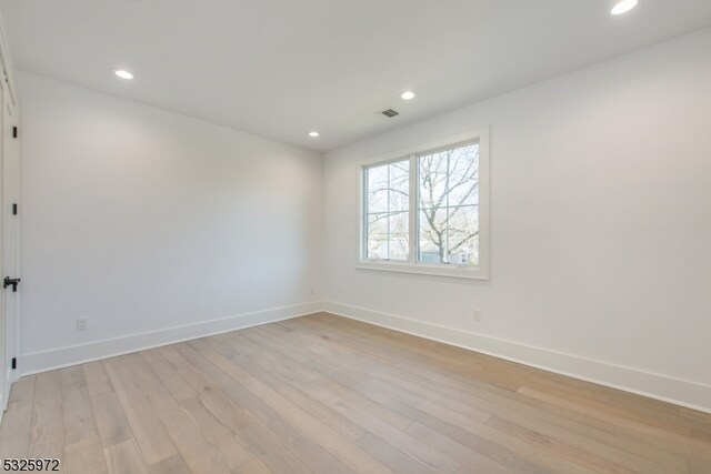 unfurnished room featuring light hardwood / wood-style floors