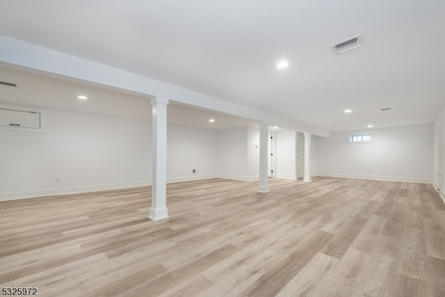 basement with light hardwood / wood-style flooring