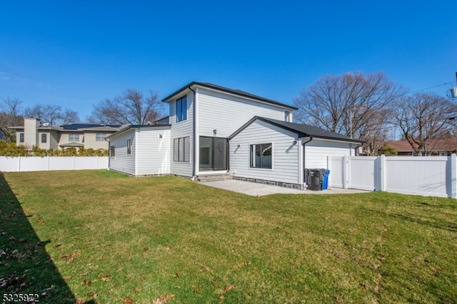 back of house with a lawn and a patio area