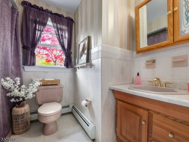 bathroom featuring vanity, tile walls, and a baseboard heating unit