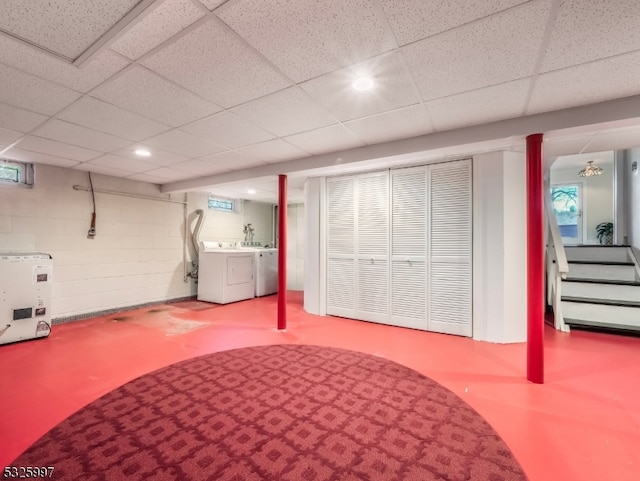 basement with washer and dryer, a paneled ceiling, and refrigerator