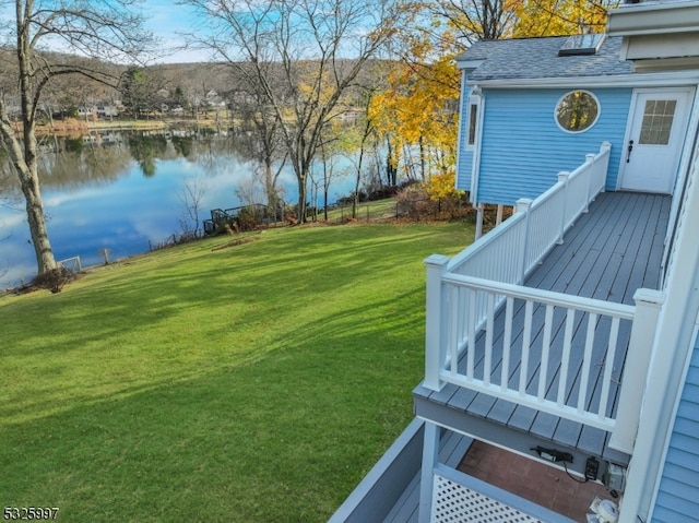 view of yard with a deck with water view