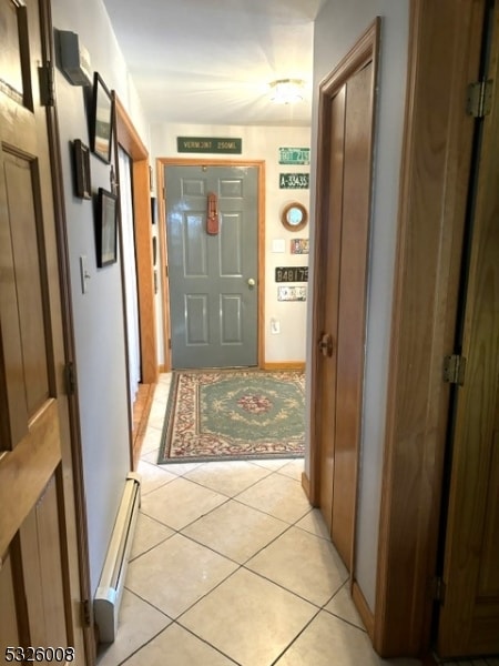 hallway with baseboard heating and light tile patterned floors