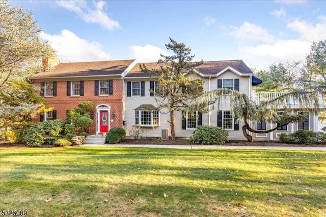 view of front of home featuring a front lawn and central AC unit