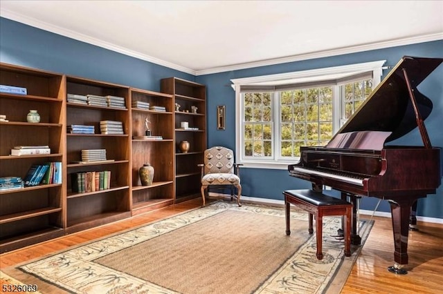 living area featuring hardwood / wood-style flooring and crown molding