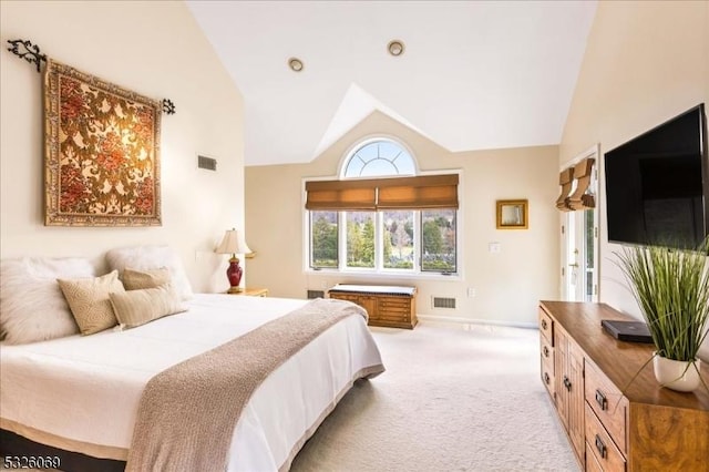 bedroom featuring light carpet and vaulted ceiling