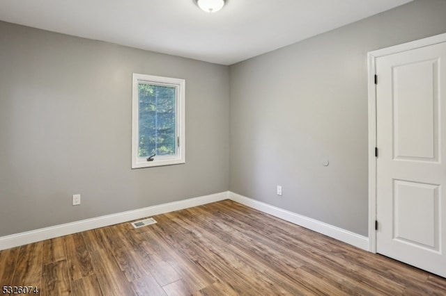 empty room featuring wood-type flooring