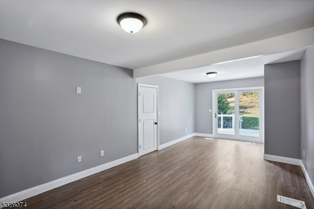 empty room featuring dark hardwood / wood-style floors