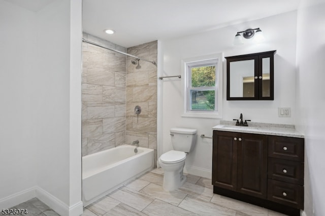 full bathroom featuring vanity, toilet, and tiled shower / bath