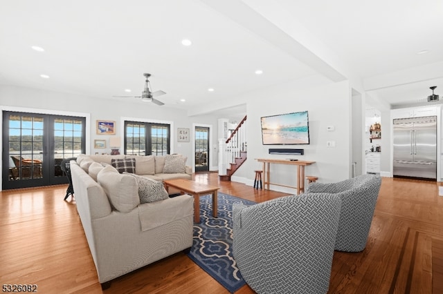 living room featuring ceiling fan, french doors, and hardwood / wood-style floors