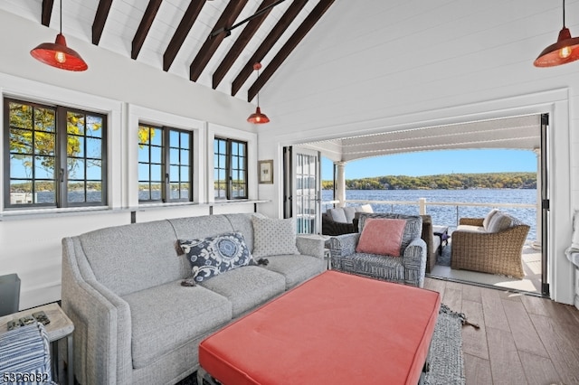 sunroom with a wealth of natural light, french doors, a water view, and lofted ceiling with beams