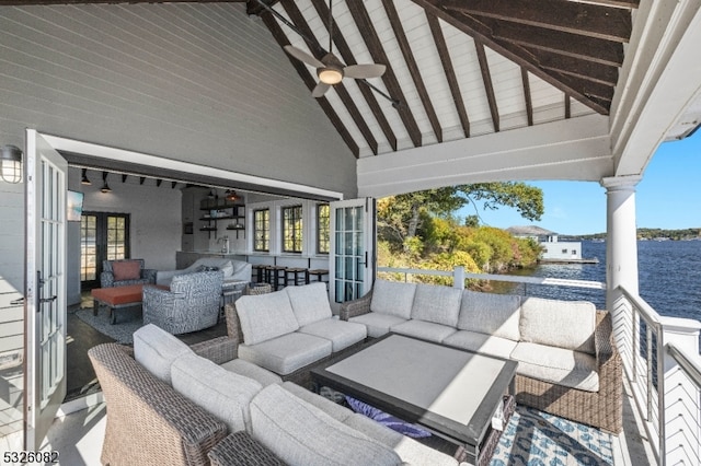 view of patio / terrace featuring outdoor lounge area, french doors, and a water view