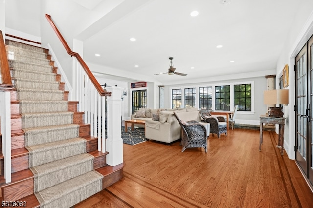 living room featuring hardwood / wood-style floors and ceiling fan