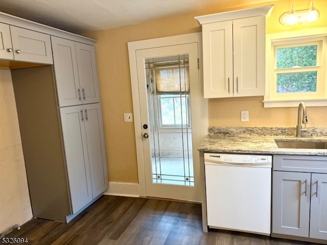 kitchen with dishwasher, dark hardwood / wood-style floors, a wealth of natural light, and sink