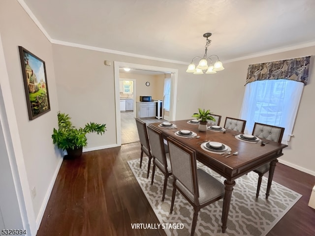 dining area with dark hardwood / wood-style floors, crown molding, and an inviting chandelier