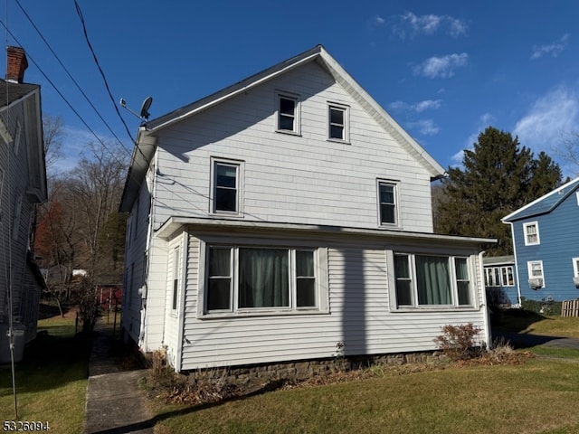 rear view of house with a lawn