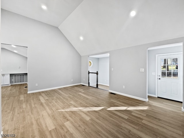 unfurnished living room with light hardwood / wood-style flooring and vaulted ceiling