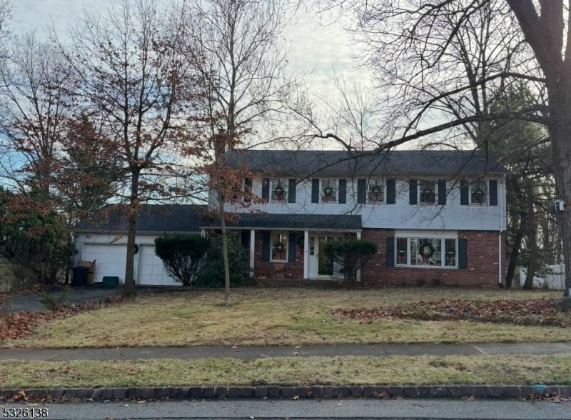 view of front facade with a front lawn and a garage