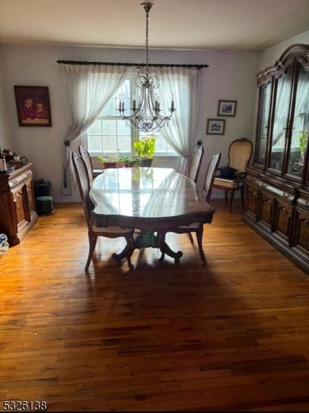 dining area featuring light hardwood / wood-style floors and a notable chandelier