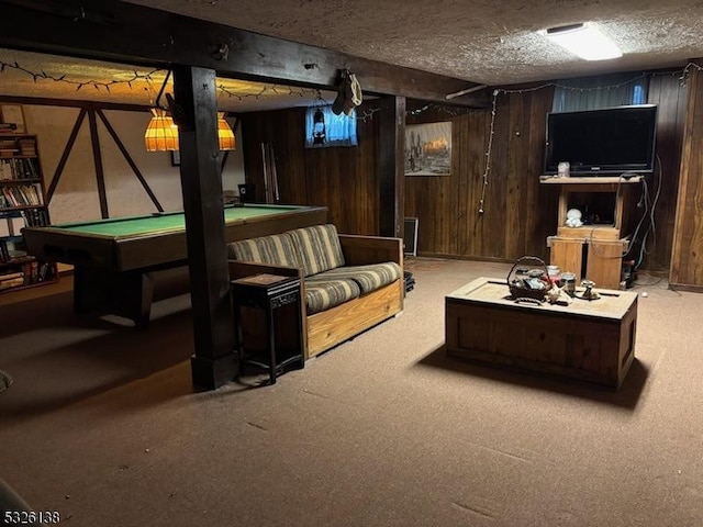 game room featuring carpet flooring, a textured ceiling, wooden walls, and pool table