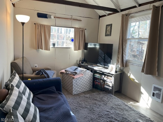 living room with vaulted ceiling with beams, wood-type flooring, and heating unit