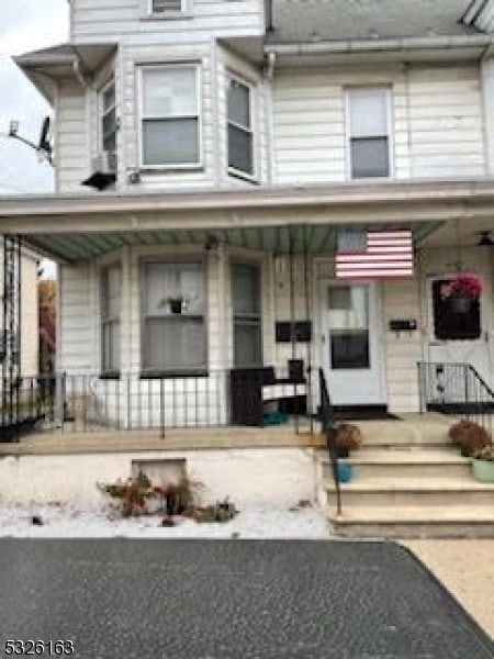 view of property featuring covered porch