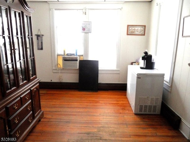 interior space featuring cooling unit and dark wood-type flooring