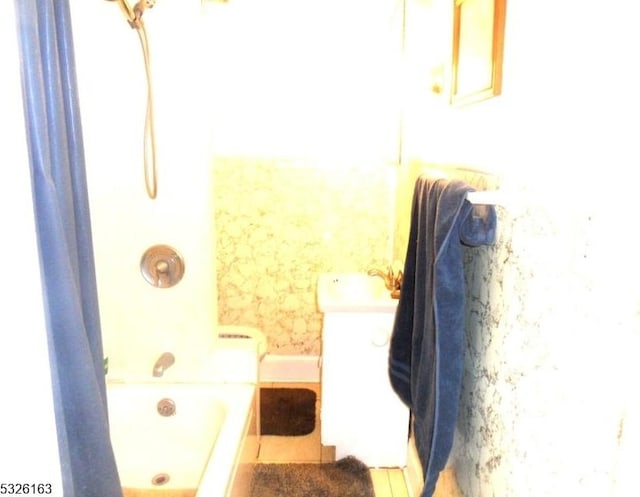 bathroom with tile patterned flooring and a tub to relax in