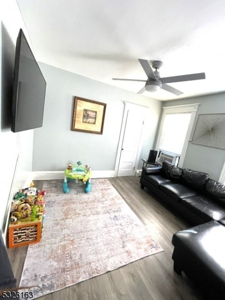 living room with hardwood / wood-style flooring and ceiling fan