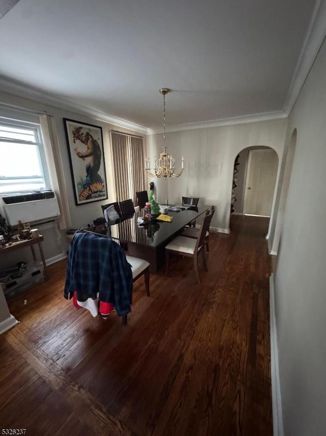 dining area featuring dark hardwood / wood-style floors, ornamental molding, and an inviting chandelier