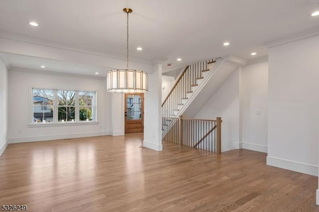 interior space featuring light wood-type flooring and ornamental molding