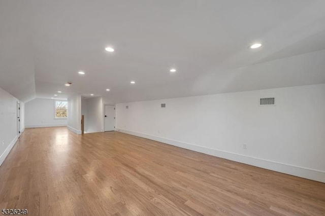 bonus room featuring light hardwood / wood-style flooring and lofted ceiling