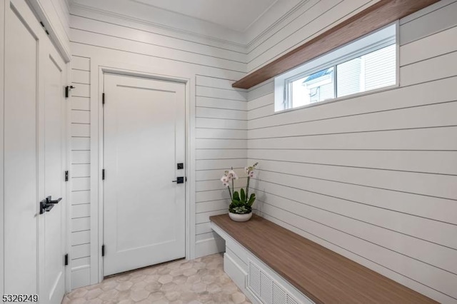 mudroom featuring wood walls