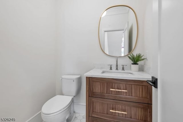 bathroom featuring tile patterned flooring, vanity, and toilet