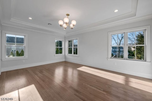 interior space featuring a notable chandelier, ornamental molding, dark wood-type flooring, and a tray ceiling