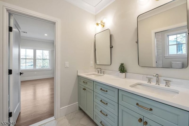 bathroom featuring vanity, toilet, a wealth of natural light, and ornamental molding