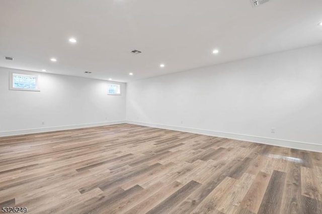 basement with a wealth of natural light and light wood-type flooring