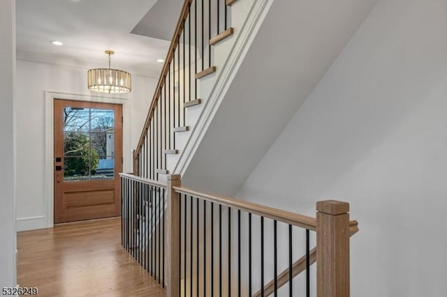 entrance foyer with light wood-type flooring and an inviting chandelier