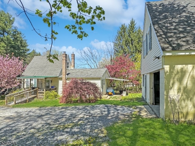 view of side of property featuring a yard and a garage