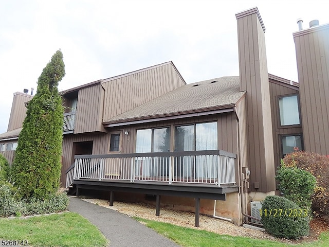 rear view of property with central air condition unit